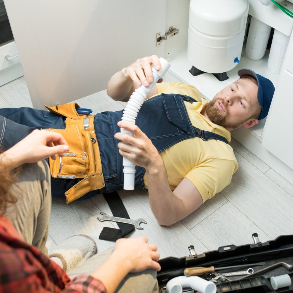 young-plumber-changing-trap-under-sink.jpg